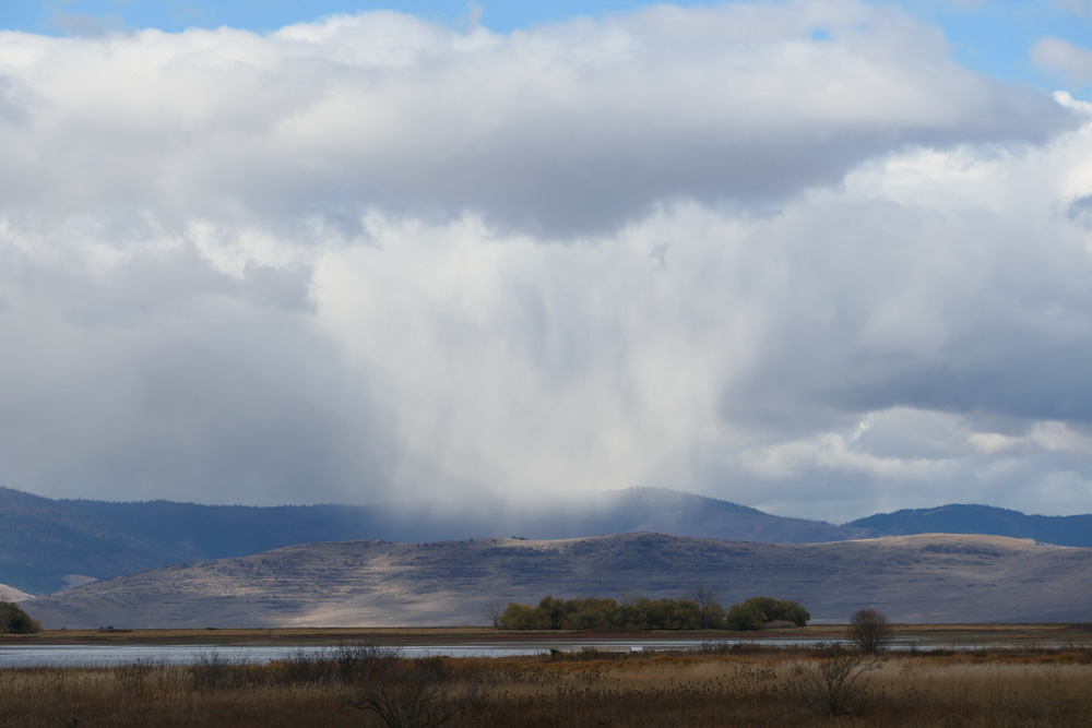 A curtain of precipitation falls from a storm system over Charlo, Montana, US.